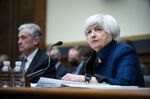 Janet Yellen, U.S. Treasury secretary, and Jerome Powell, chairman of the U.S. Federal Reserve, left, listen during a House Financial Committee hearing in Washington, D.C., U.S., on Wednesday, Dec. 1, 2021. Stocks slid, short-term interest rates rose and measures of equity volatility surged Tuesday after the central bank chairman warned Congress that elevated inflation could justify ending asset purchases sooner than planned.