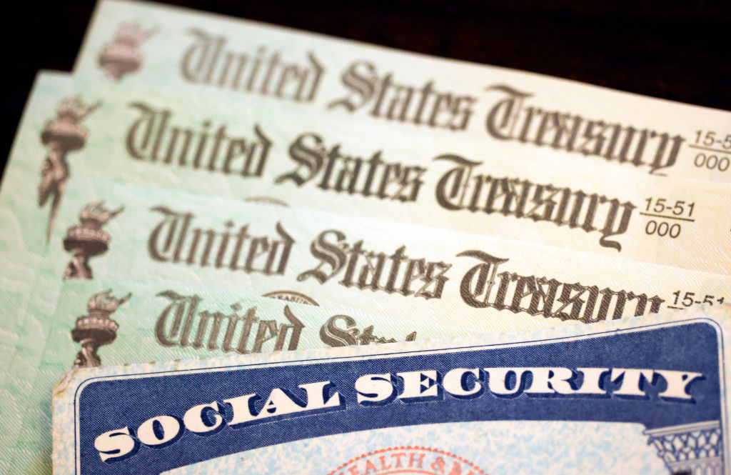 WASHINGTON, DC - OCTOBER 14: In this photo illustration, a Social Security card sits alongside checks from the U.S. Treasury on October 14, 2021 in Washington, DC. The Social Security Administration announced recipients will receive an annual cost of living adjustment of 5.9%, the largest increase since 1982. The larger increase is aimed at helping to offset rising inflation. (Photo illustration by Kevin Dietsch/Getty Images)