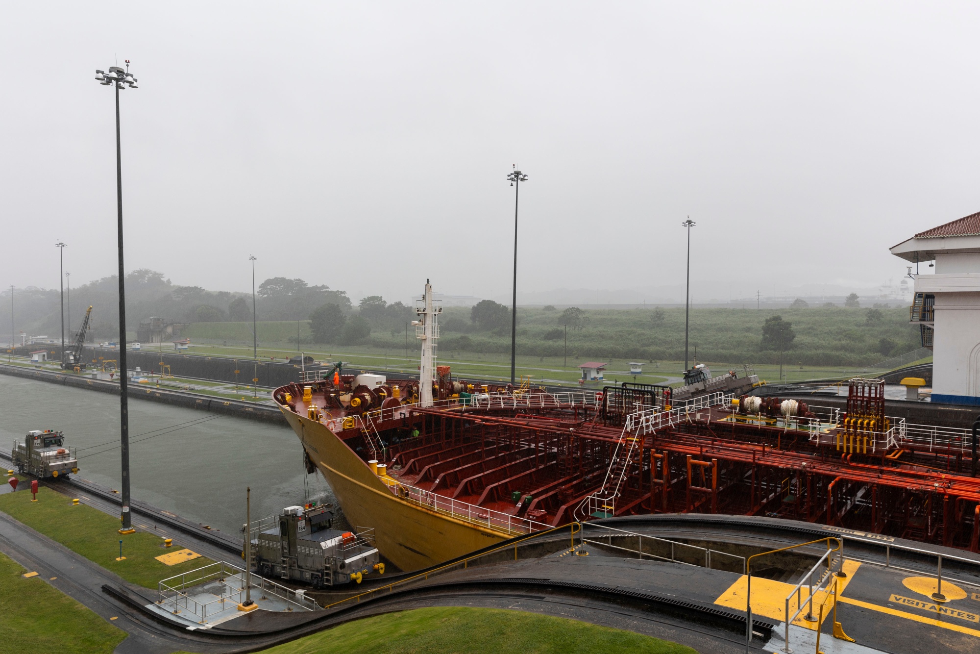 A tanker ship navigates through the Miraflores locks of the Panama Canal.