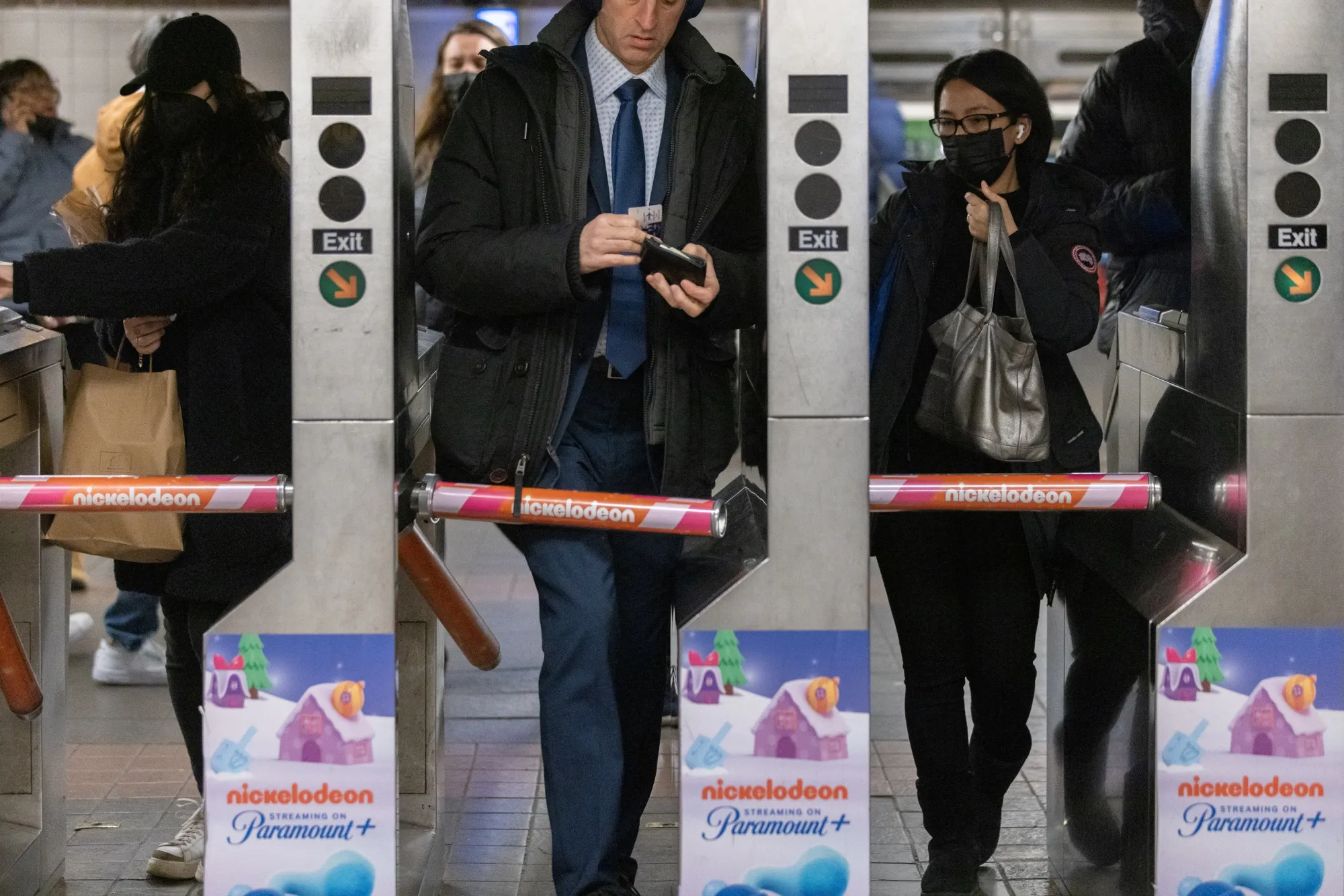 Commuters enter a subway station in New York.