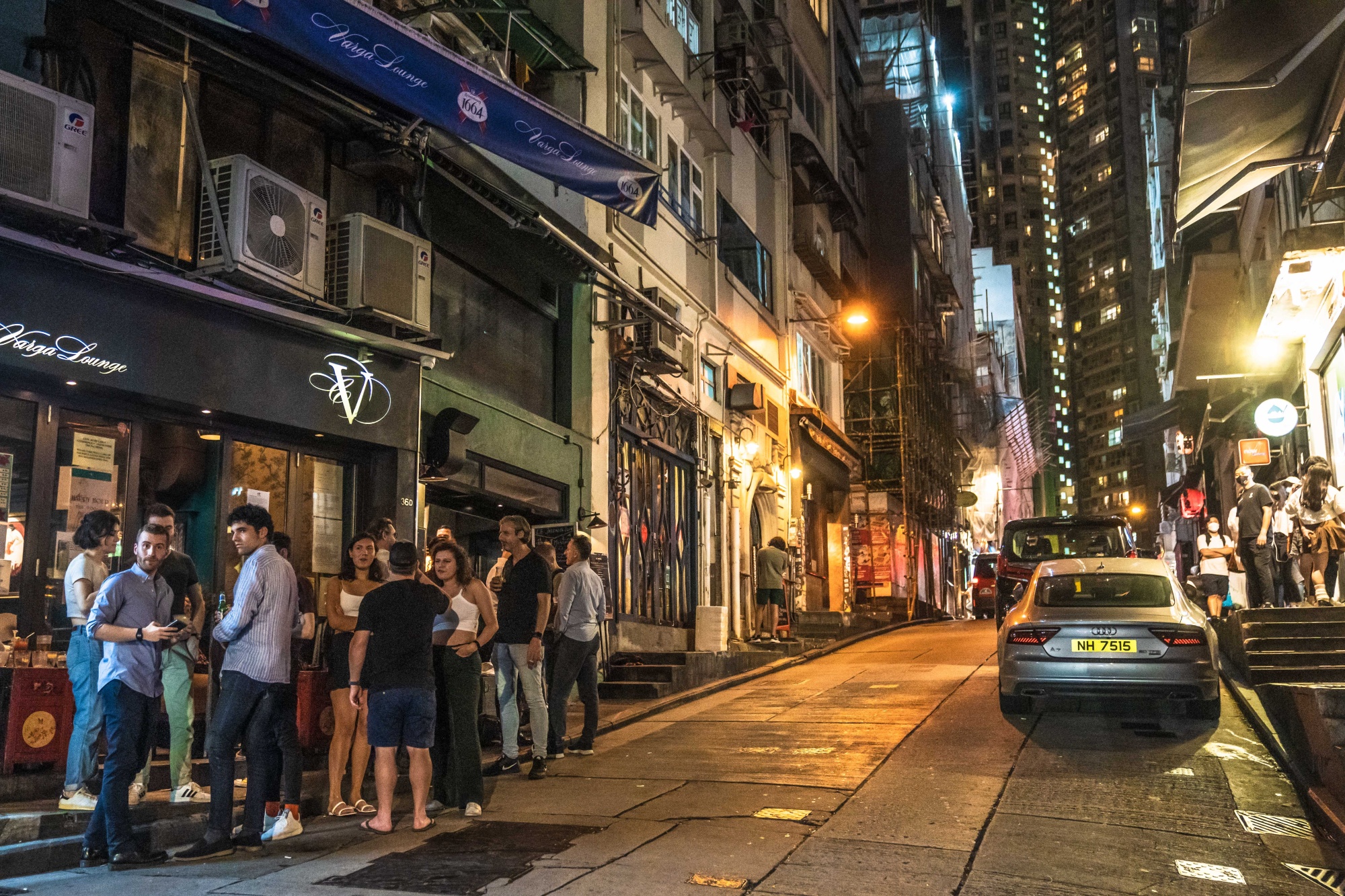 Customers outside a bar at the Lan Kwai Fong nightlife area in Hong Kong.