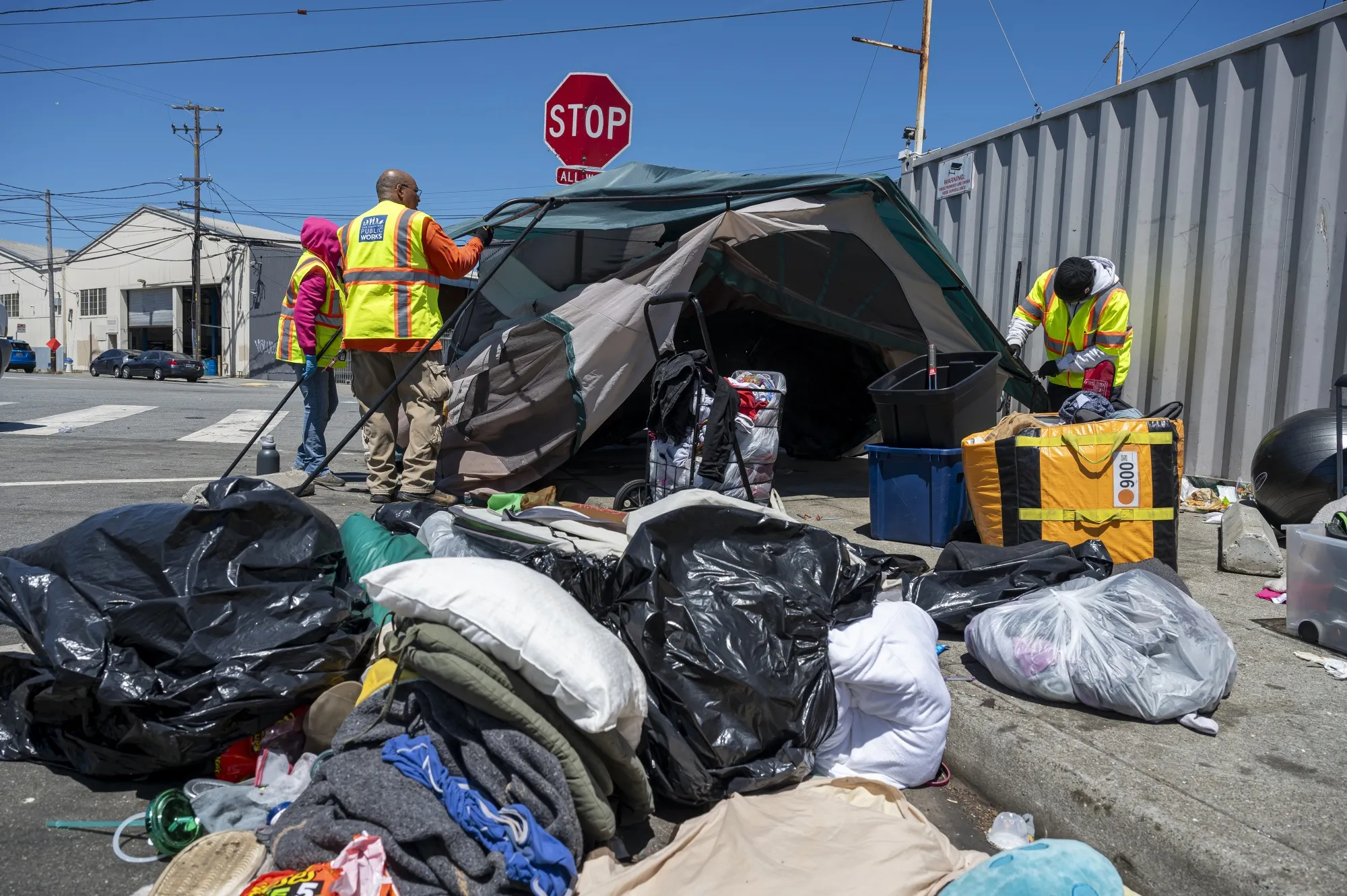 Workers remove a homeless encampment in San Francisco’s Bayview neighborhood on Aug. 1.