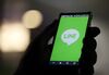 A man uses a smartphone displaying the logo of Line Corp., controlled by Naver Corp., in this arranged photograph in Tokyo, Japan.