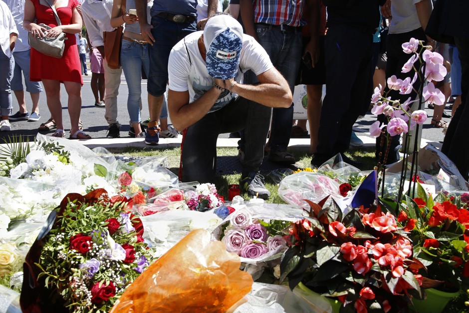 People leave bouquets of flowers in tribute to the victims in Nice, France.