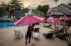 This picture taken on February 6, 2020 shows a worker moving an umbrella at a nearly empty resort at Ao Nang beach in Krabi province as the tourism industry sees a drop in the number of Chinese tourists due to the deadly COVID-19 outbreak. 