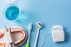 Dental hygiene background. Top view of dental care equipment on blue background.
