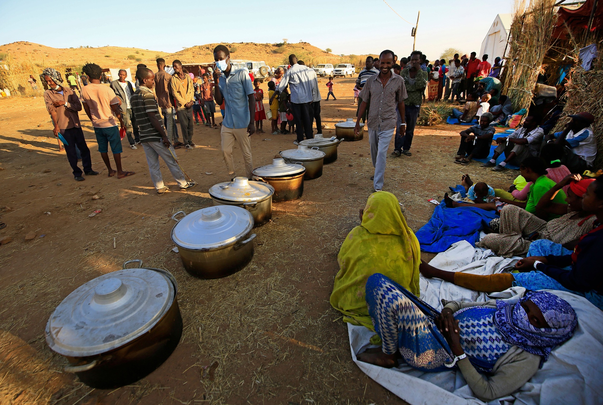Ethiopian refugees from Tigray province wait for food at a camp in Sudan's Gedaref province on Nov. 21.