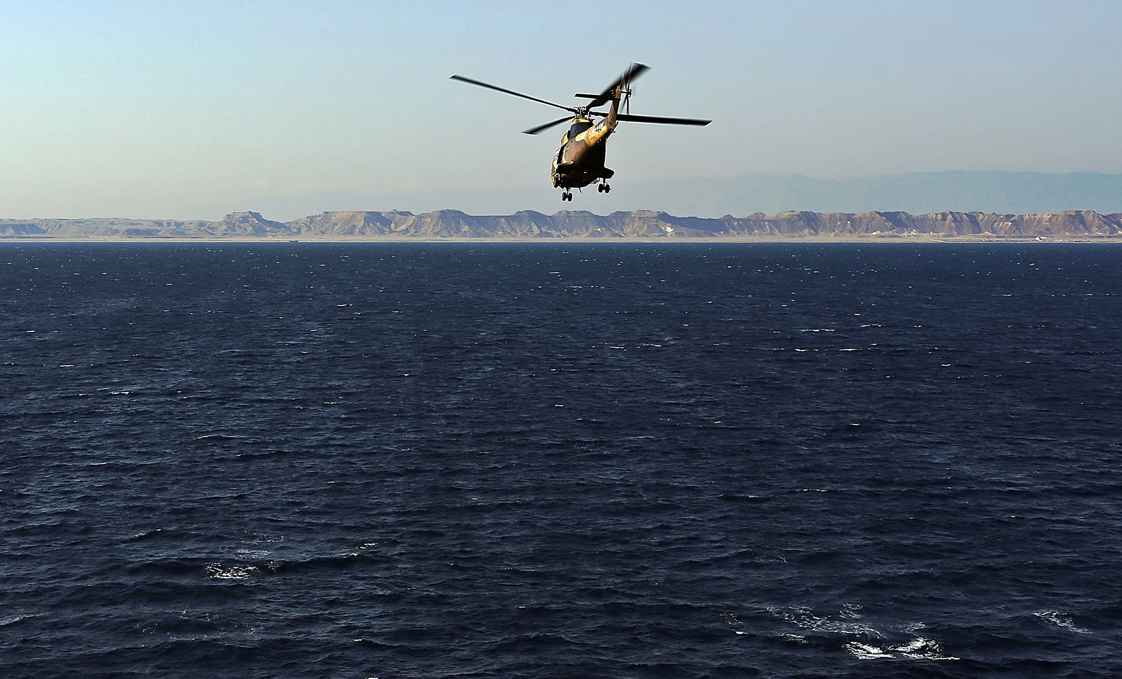 A French-army helicopter transporting marines attached to the European Union naval Force, EUNAVFOR-Somalia, is seen from the FS Sirocco heading towards the coast of Somalia's nothern semi-autonomous region of Puntland, on March 27, 2014.
