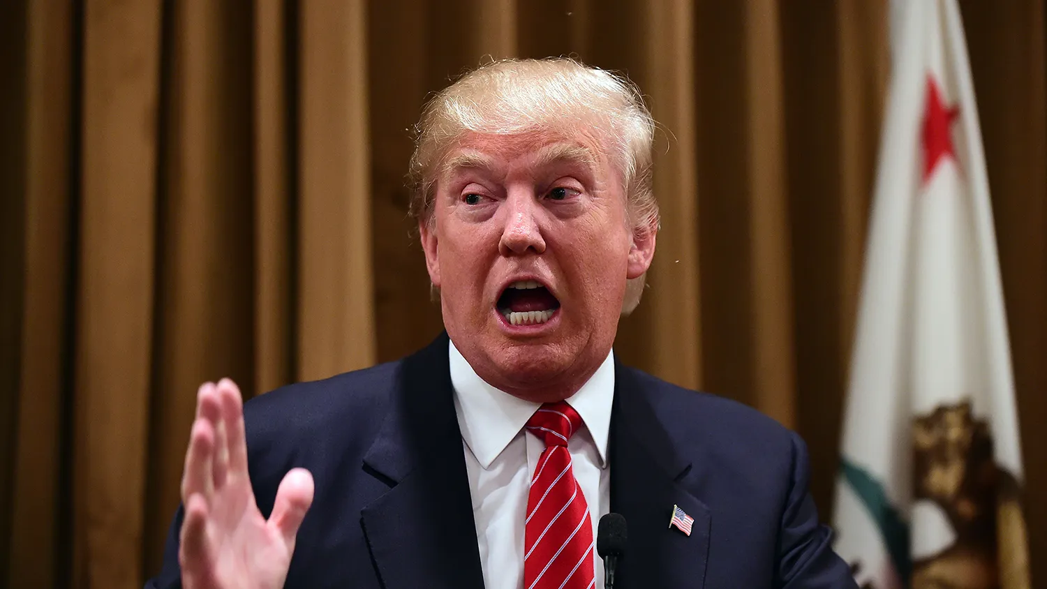 Donald Trump gestures at a press briefing where he introduced people whose families were victims of illegal immigrants on July 10, 2015 at the Beverly Wilshire Hotel in Beverly Hills, California, where some shared their stories of the loss of a loved one.
