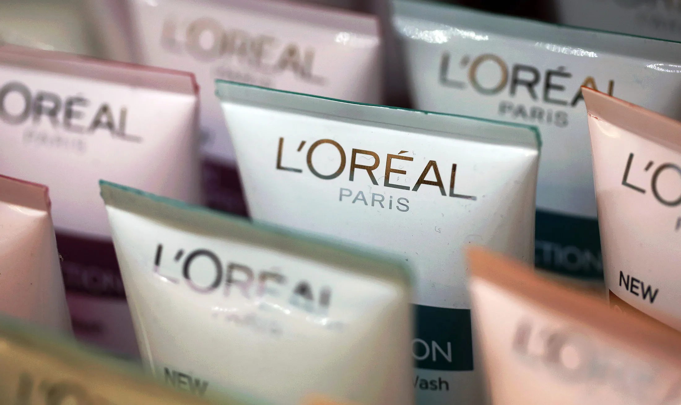Tubes of L'Oreal Skin Perfection cream, manufactured by L'Oreal SA, sit for sale inside a pharmacy in London, U.K., on Tuesday, Feb. 11, 2014. L'Oreal, the world's largest cosmetics company, agreed to buy back 8 percent of its stock for 6 billion euros ($8.2 billion) from Nestle SA, which has been an investor for 40 years.
