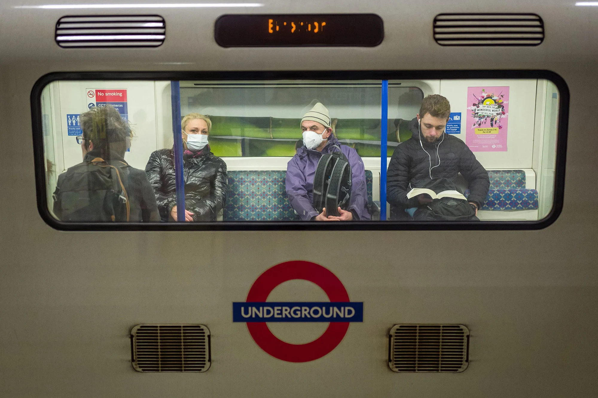 Passengers wear protective face masks as they travel on an underground train&nbsp;in London on March 15.&nbsp;