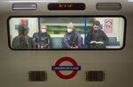Passengers wear protective face masks as they travel on an underground train&nbsp;in London on March 15.&nbsp;
