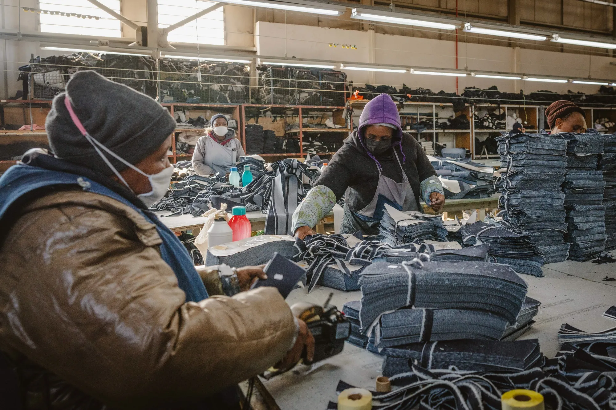 Workers prepare cuts of denim cloth at the Afri-Expo Textiles Ltd. denim factory in Maseru, Lesotho.