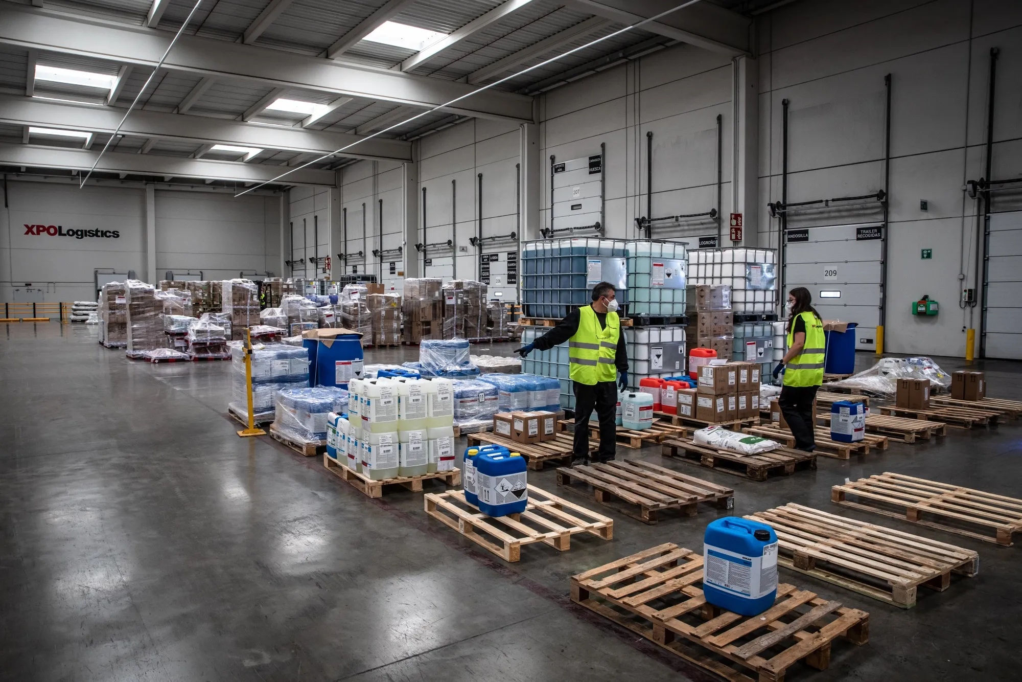 Workers sort pallets of goods at an XPO Logistics Inc. distribution hub in Barcelona, Spain.