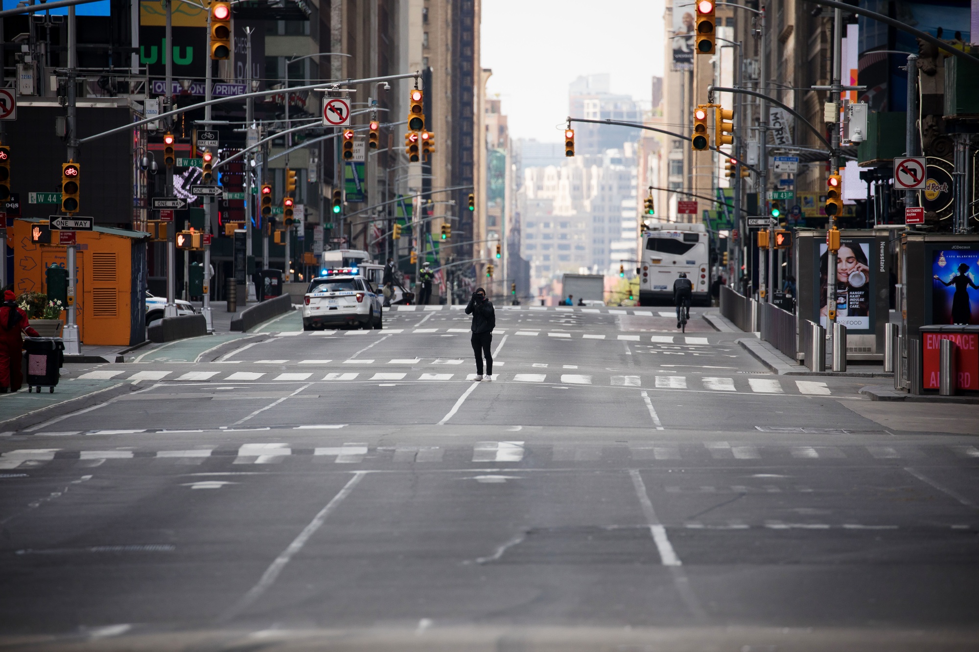 A pedestrian walks through a nearly empty Times Square in New York.