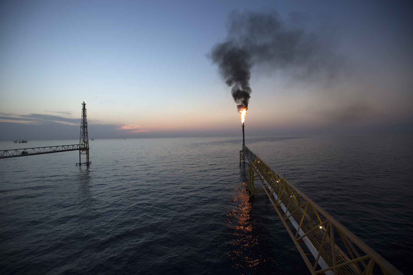 Gas flares from a burner tower on the Petroleos Mexicanos (Pemex) Pol-A Platform complex, located on the continental shelf in the Gulf of Mexico.