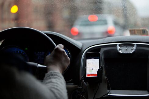 The Uber Technologies Inc. application runs on an Apple Inc. iPhone during an Uber ride in Washington, D.C., on April 8, 2015.