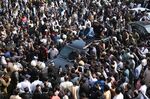 Supporters gather around a vehicle carrying Imran Khan in Lahore, Pakistan, on March 21.