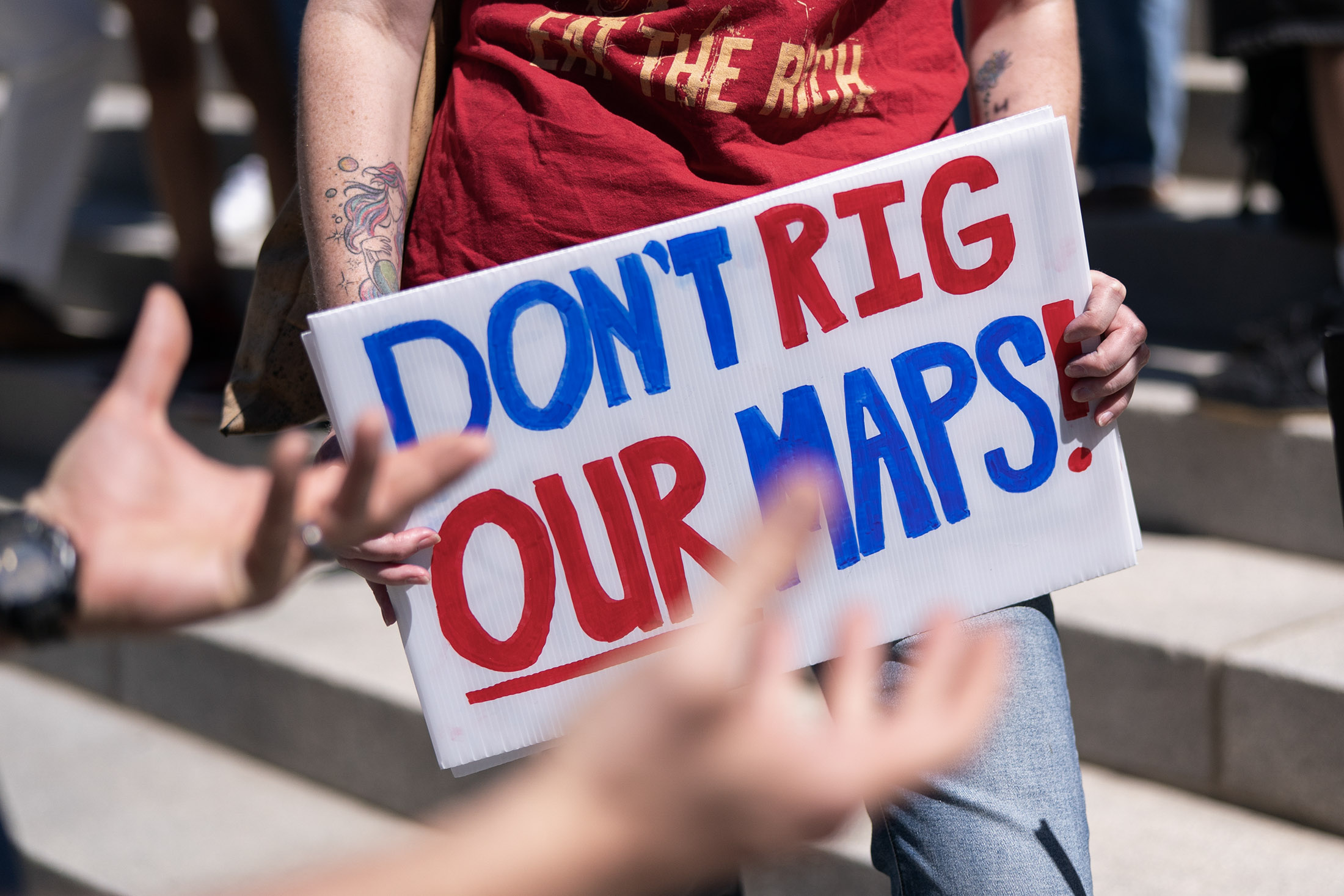 Demonstrators gather on the statehouse steps during a rally in opposition to congressional redistricting in Columbia, South Carolina. Photographer: Sean Rayford/Getty Images 