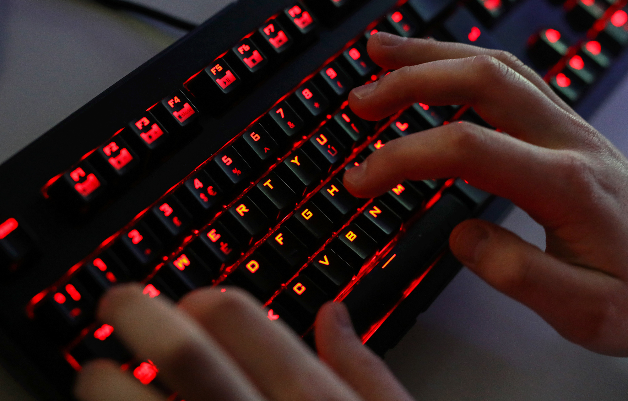 An employee uses a keyboard while playing computer games