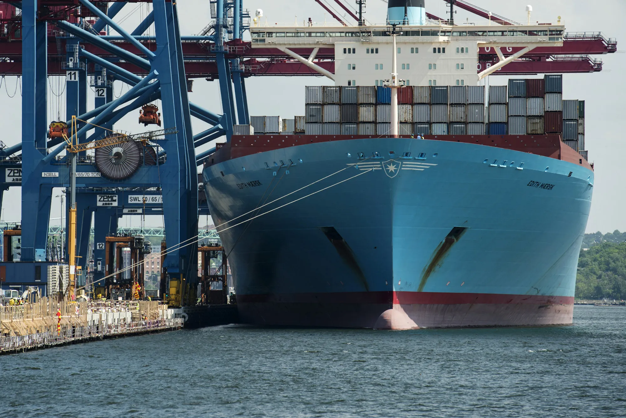 The container ship Edith Maersk, operated by AP Moeller-Maersk A/S, stands beneath gantry cranes during loading and unloading operations at the dockside in the Port of Gothenburg in Gothenburg, Sweden, on Tuesday, May 28, 2013. Sweden's economy grew twice as fast as predicted in the first quarter, sapping speculation that the central bank will need to cut interest rates at its July meeting.
