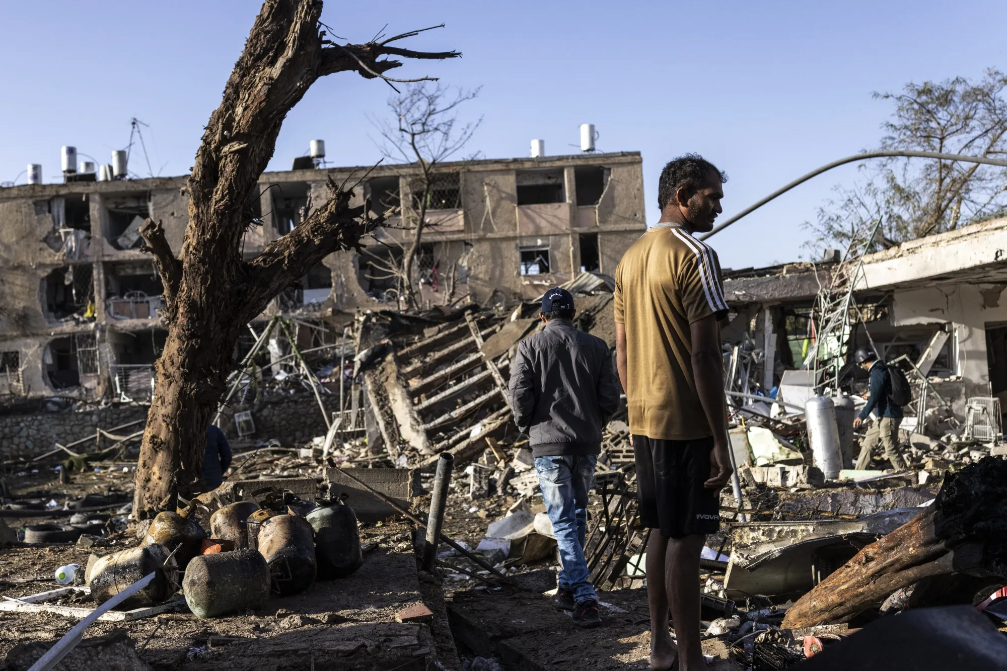 People inspect the site of an Iranian missile strike in Dimona, Israel. on March 22.
