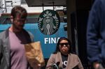 Pedestrians walk past a Starbucks coffee shop in San Francisco, California, U.S., on Thursday, April 28, 2022. 
