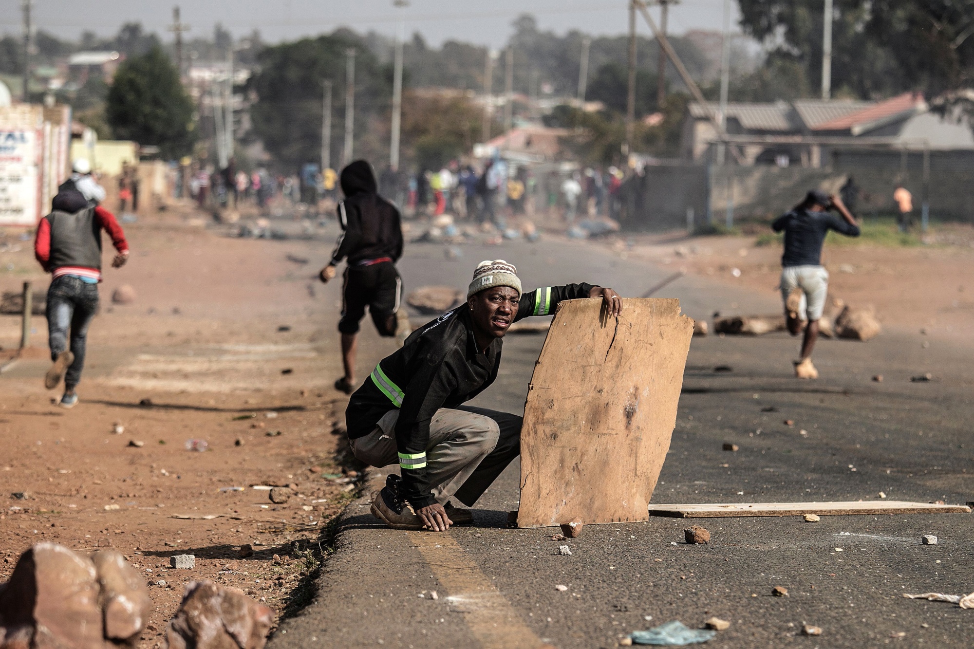 Residents clash with police during a protest for better housing in May 2017, in Ennerdale, south of Johannesburg. The area is mostly made up of informal settlements.