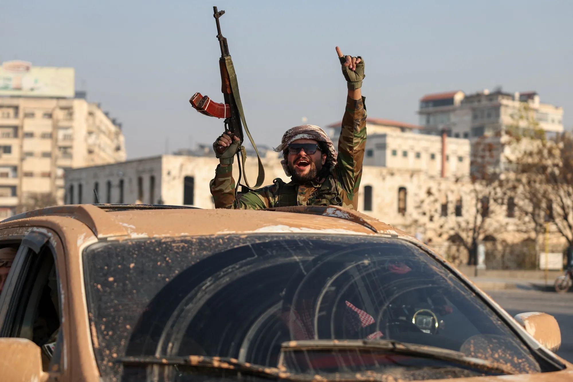 An anti-government fighter patrolling the streets of Hama after they captured the central Syrian city, on Dec. 6.