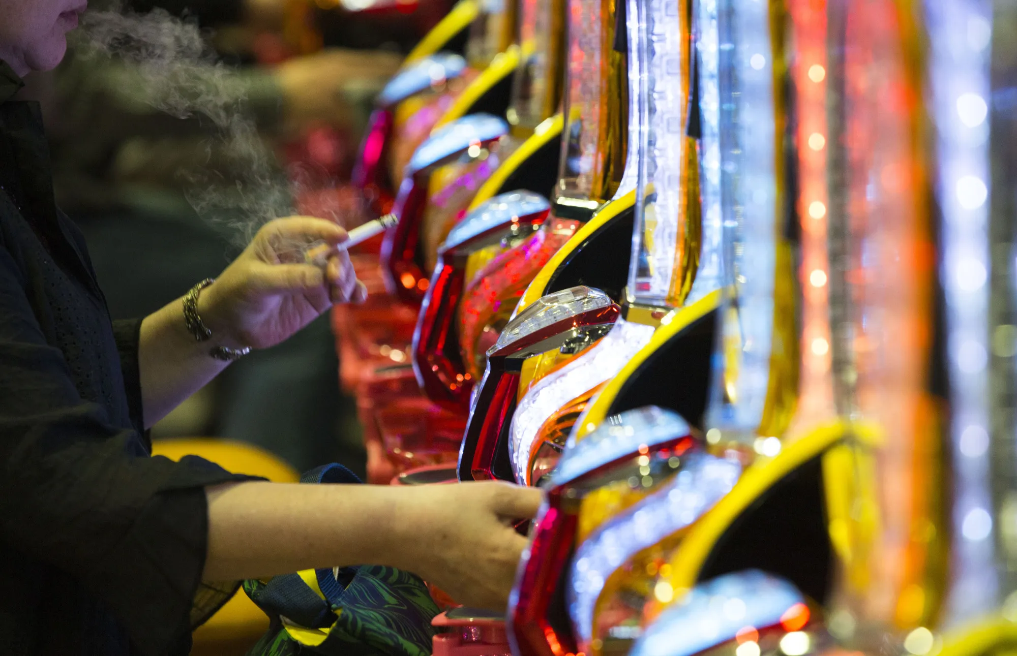 A customer smokes a cigarette inside the pachinko parlor in Tokyo.