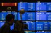 A screen displas share prices inside the Tokyo Stock Exchange.