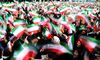 TOPSHOT - Iranian schoolgirls wave their national flag during celebrations in Tehran's Azadi Square (Freedom Square) to mark the 37th anniversary of the Islamic revolution on February 11, 2016. / AFP / ATTA KENARE (Photo credit should read ATTA KENARE/AFP/Getty Images)