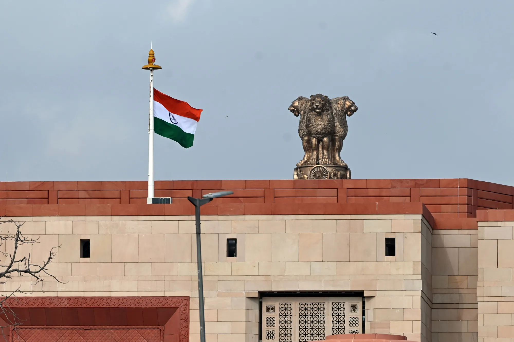 An Indian flag flies above the new Parliament building in New Delhi, India.