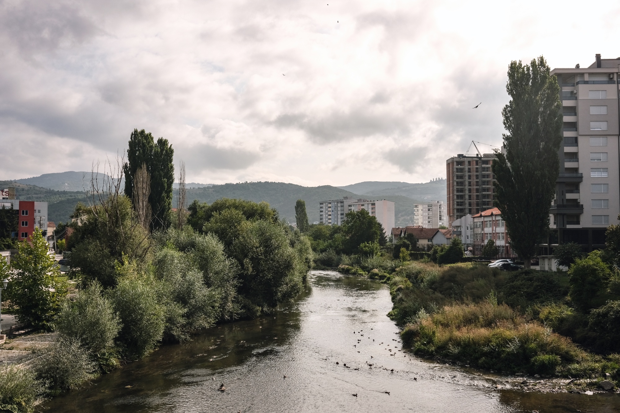 The Ibar River, which divides ethnic Serb and Albanian communities, in Mitrovica, Kosovo, on Wednesday, Aug. 24. The bridge across the river has failed to link the communities on either side of the town, where to the south lies the vibrant part of Mitrovica that's home to the ethnic Albanian majority and to the north, mainly ethnic Serb citizens live in limbo, paralyzed by the region's intransigent politics. Photographer: Ben Kilb/Bloomberg