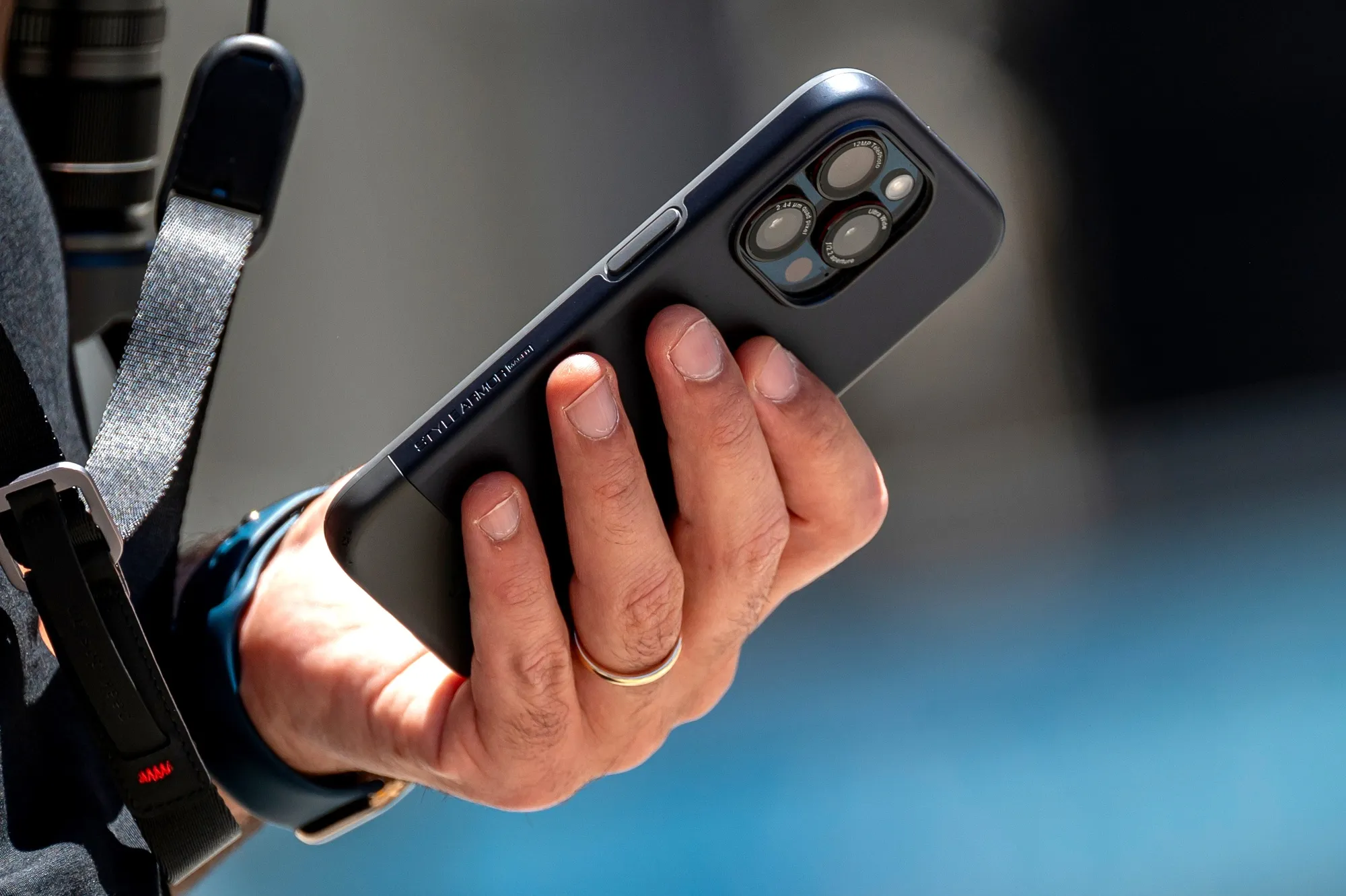 A pedestrian uses an iPhone in front of an Apple store in San Francisco, California.