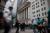 Pedestrians pass in front of the New York Stock Exchange (NYSE) in New York, U.S., on Tuesday, Dec. 31, 2019. U.S. stocks fell in thin end-of-year trading, as rising tensions in the Middle East drove some profit taking after one of the strongest years for equities in the past decade.