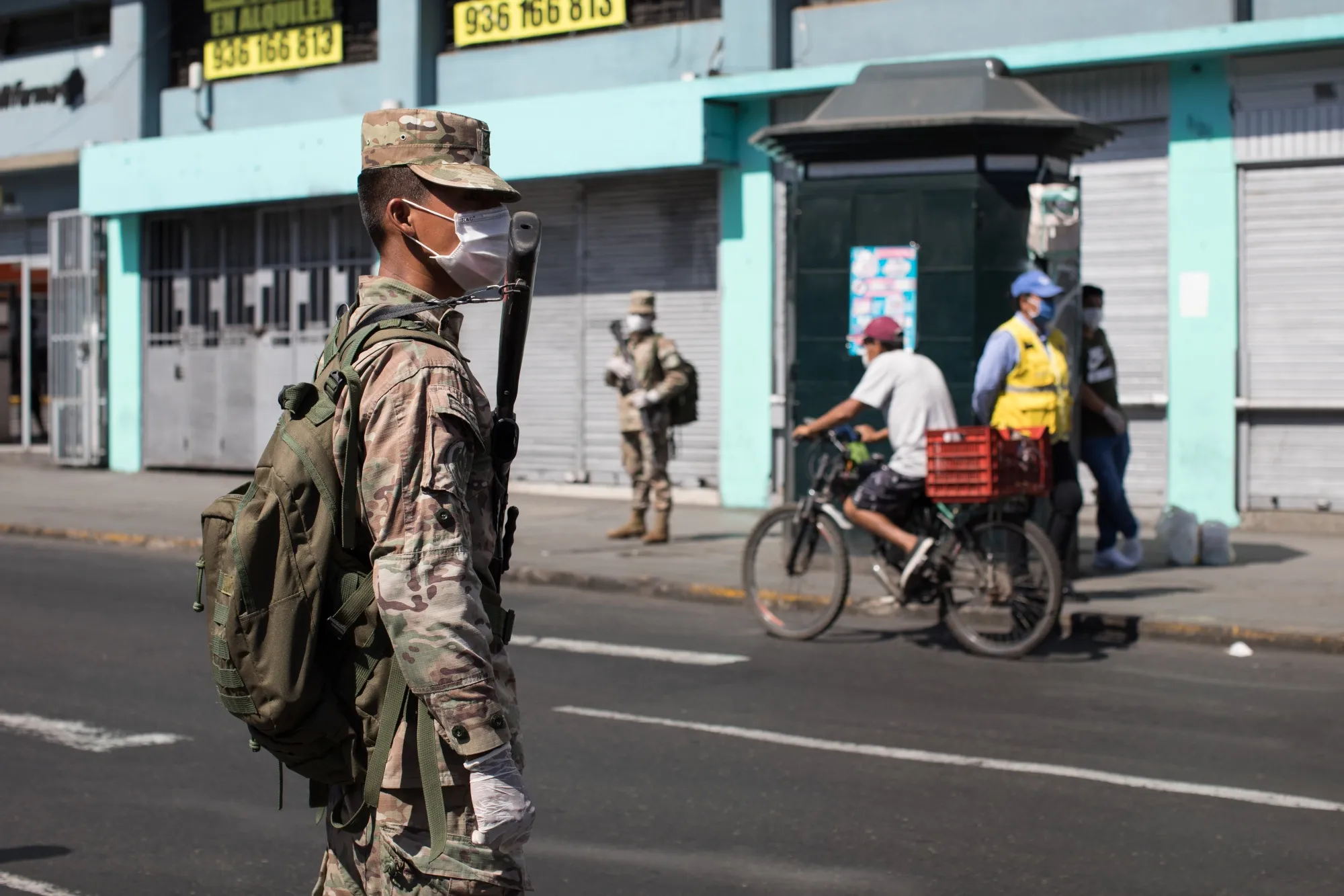 A member of the military wearing a protective mask stands guard in the historic center of Lima, Peru, on&nbsp;April 17.