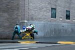 EMS workers transport a patient on the side walk outside of Mount Sinai hospital in New York on April 13.