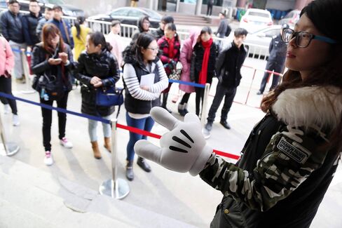 Applicants wait in line at a job fair for a chance to work at the Shanghai Disney Resort on March 2.