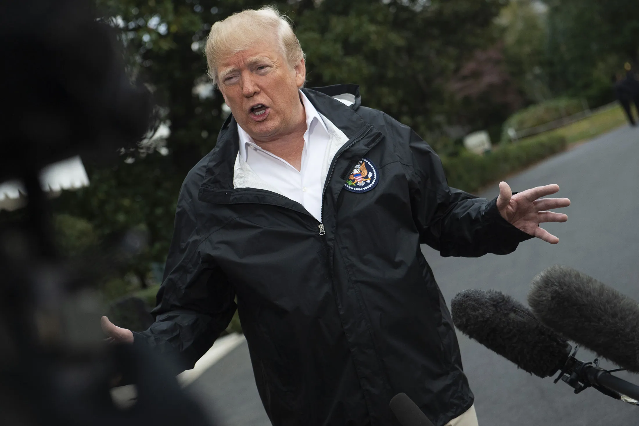 Donald Trump talks to members of the media&nbsp;as he leaves the White House to visit the California fire disaster area on Nov. 17.