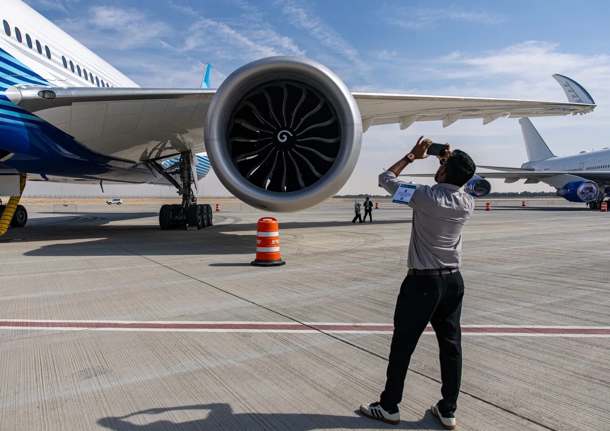 An attendee photographs a&nbsp;GE9X engine on a Boeing 777X aircraft at the Dubai Air Show in Dubai, United Arab Emirates on Nov. 17.