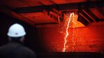 A worker watches as red hot molten liquid copper flows from a furnace into a ladle at the RTB Bor Group copper mining and smelting plant in Bor, Serbia, on Thursday, Dec. 17, 2015. Industrial metals climbed, paring weekly losses, as Chinese copper smelters may build inventories to support prices after they announced plans to cut production next year.
