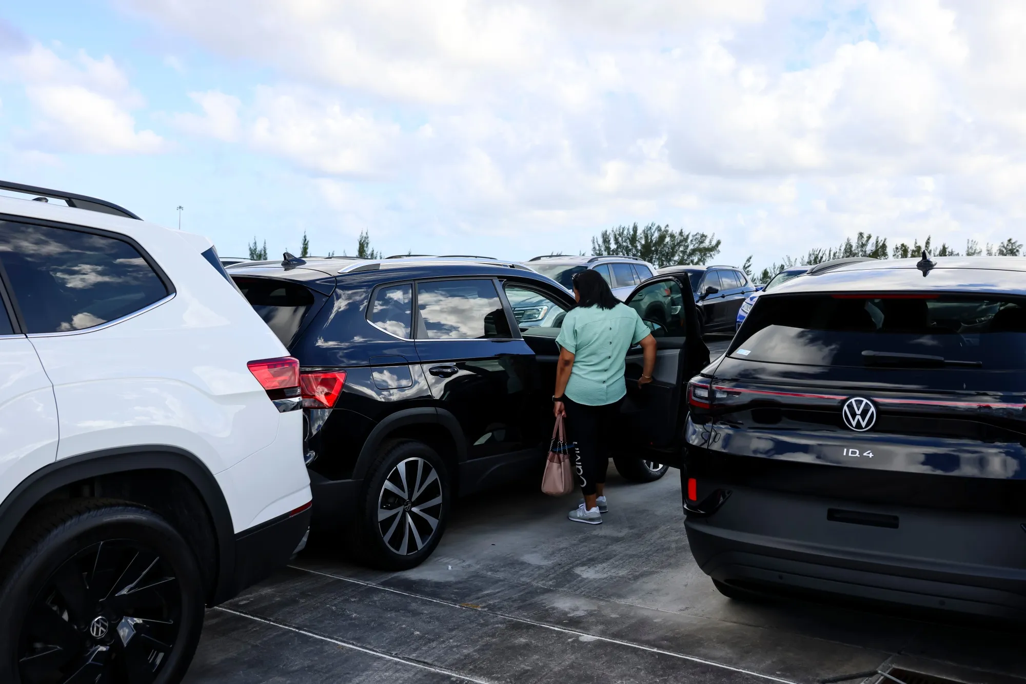 A customer views a new vehicle displayed for sale at a Volkswagen AG&nbsp;dealership in Miami, Florida, in April.