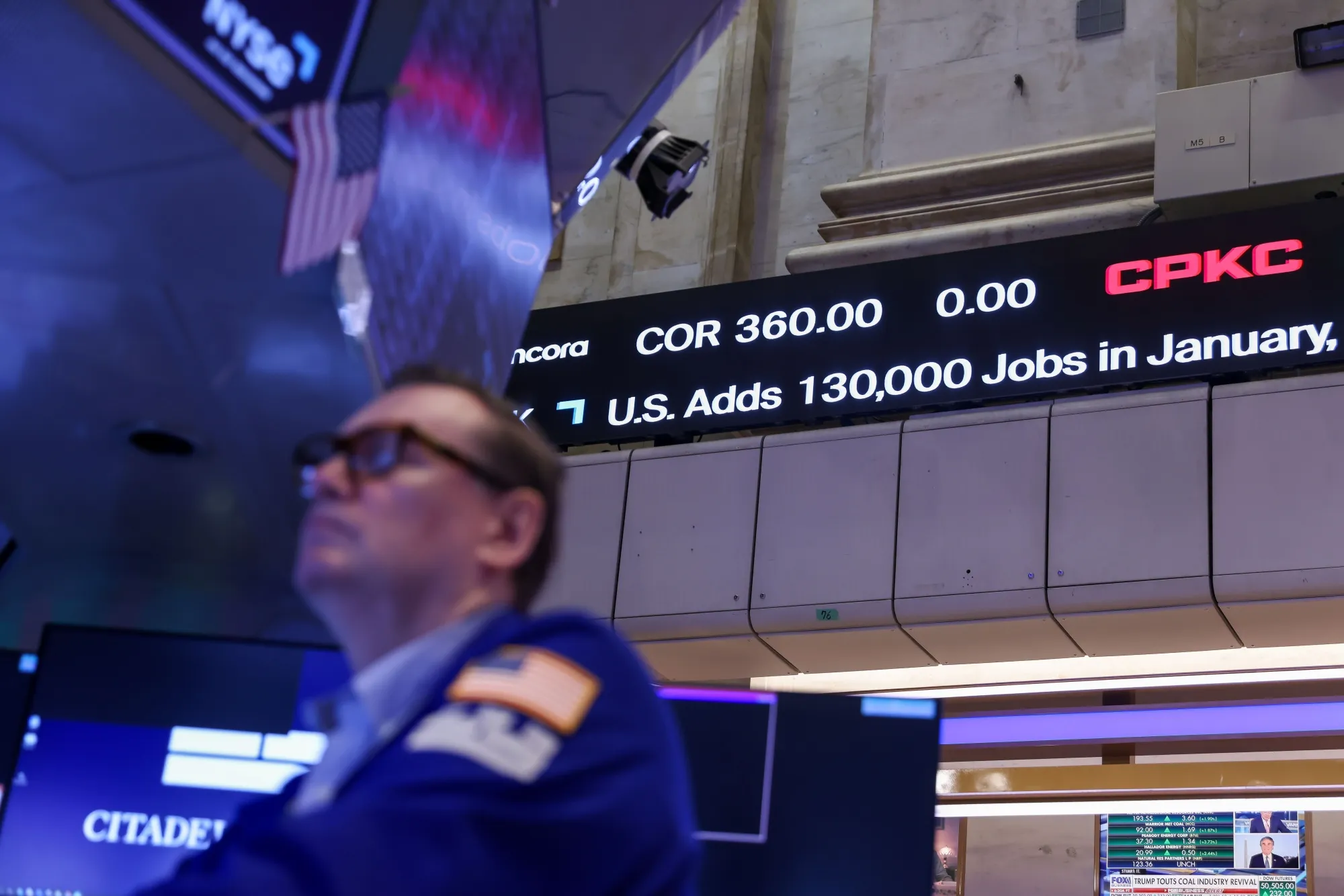 Traders work during the AGI Inc. initial public offering (IPO) on the floor of the New York Stock Exchange (NYSE) in New York, US, on Wednesday, Feb. 11, 2026. Brazilian fintech AGI Inc. raised $240 million in a US initial public offering after reducing the size and price range of the deal on Tuesday.