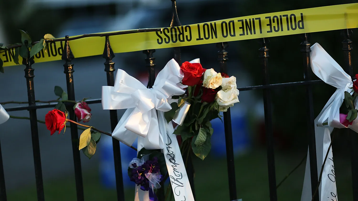 Flowers and ribbons are hung on a fence among the memorial on the sidewalk in front the Emanuel African Methodist Episcopal Church after a mass shooting at the church killed nine people on June 20, 2015 in Charleston, United States.

