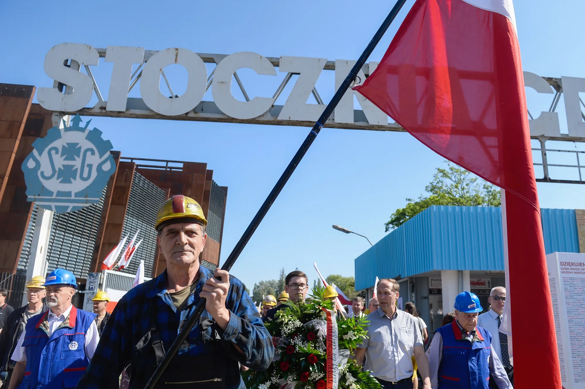Members of the Solidarity trade union walk by the Gdansk Shipyard gate during anniversary events on June 4.