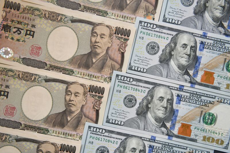 Japanese 10,000 yen, left, and US 100 dollar banknotes arranged for a photograph