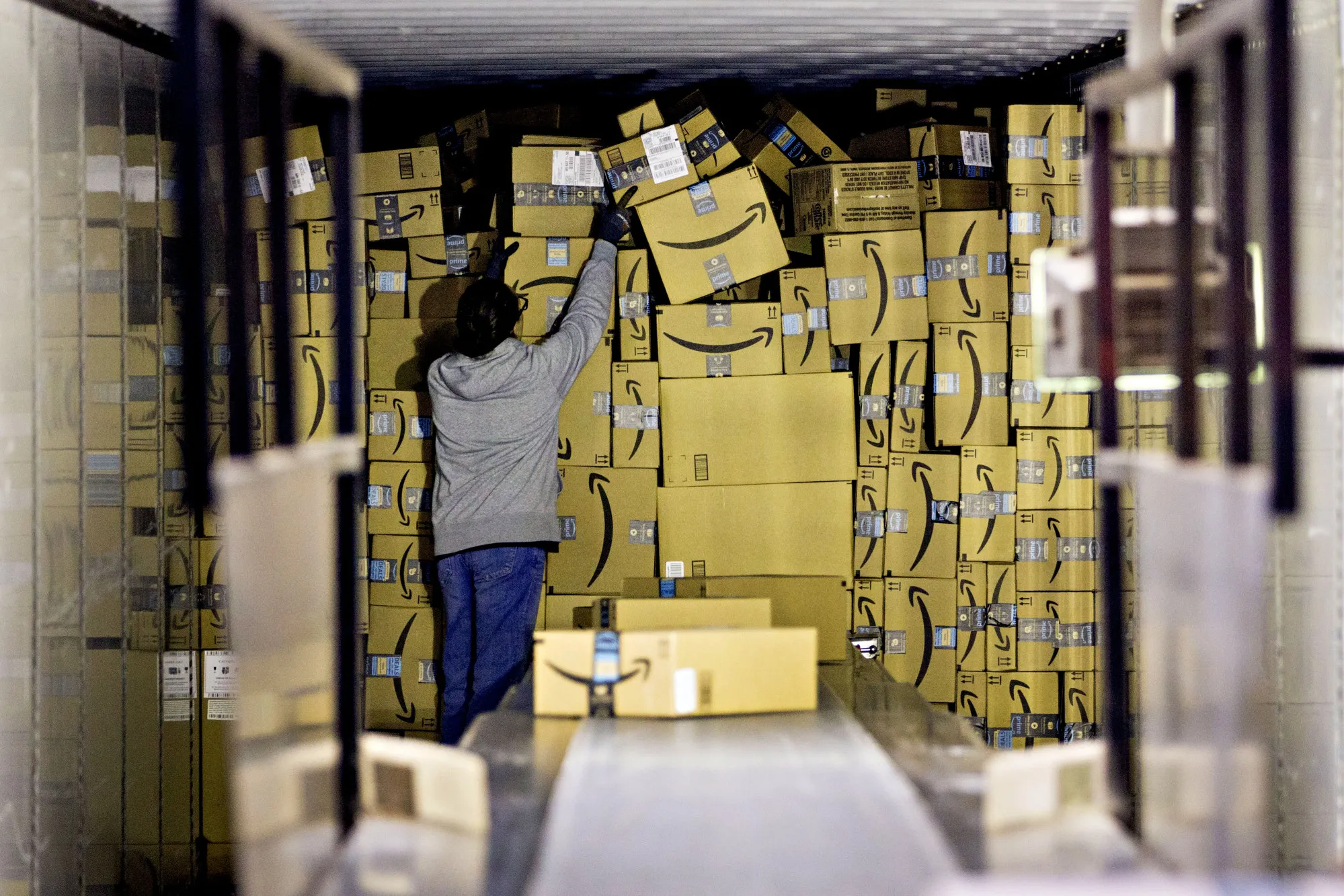 An employee unloads a truck load of Amazon.com Inc. packages at a UPS hub on Dec. 5.&nbsp;