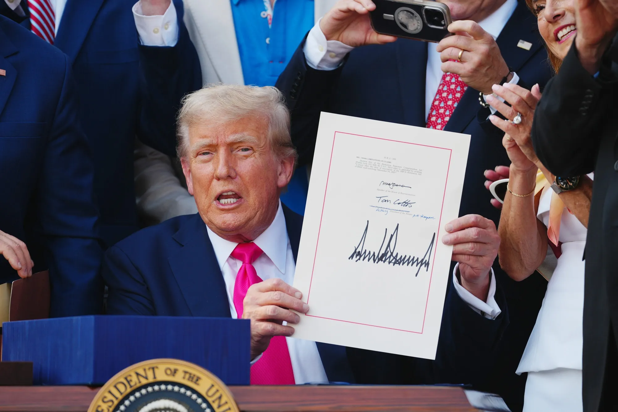 US President Donald Trump displays the signed One Big Beautiful Bill Act on the South Lawn of the White House in Washington, DC, on July 4.