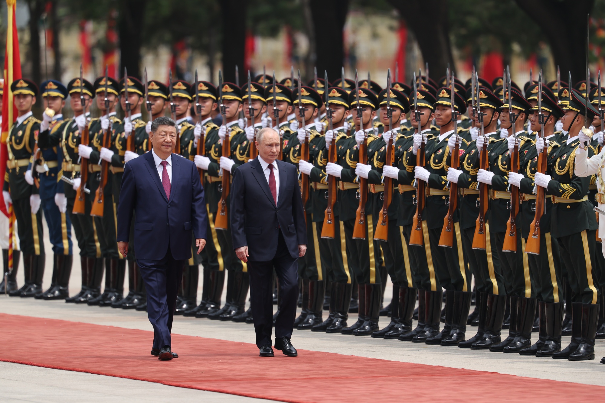 Xi Jinping and Vladimir Putin inspect an honor guard during a welcoming ceremony at the Great Hall of the People in Beijing on May 20. Photographer: Maxim Shemetov/Pool/AP